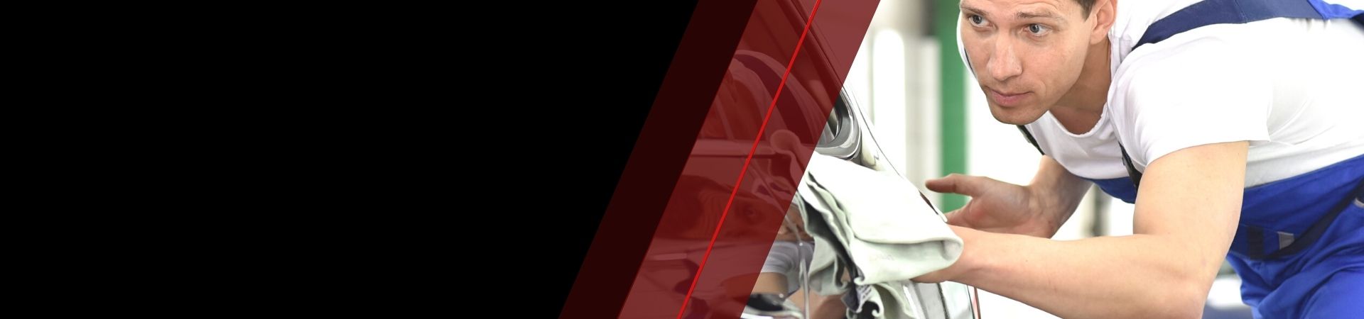 Image depicts a professional car detailer cleaning a car.